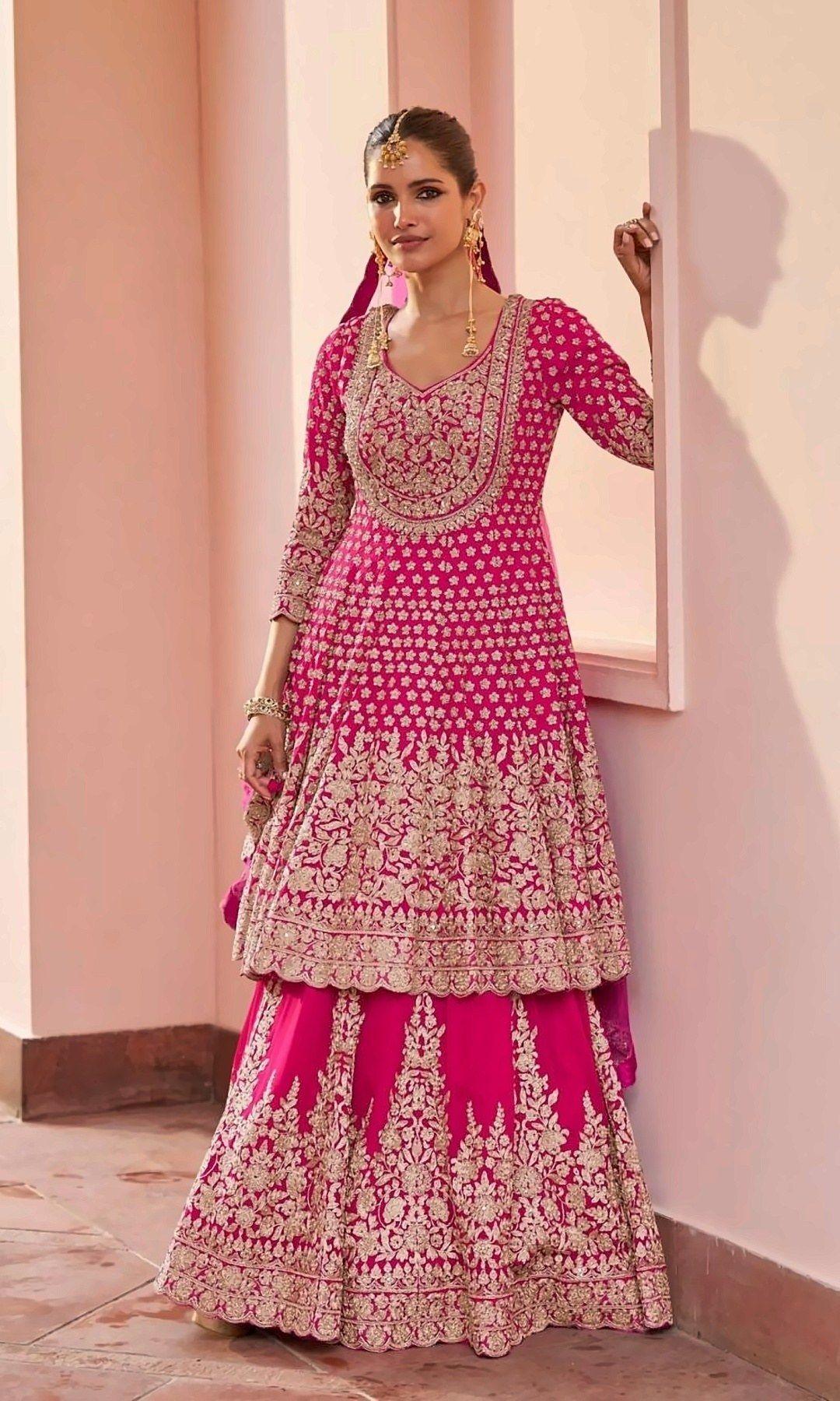Rani Pink Anarkali Lehenga Set — Rani pink peplum anarkali covered in gold floral embroidery and scattered butis, over a richly embroidered lehenga — made for celebrations.
