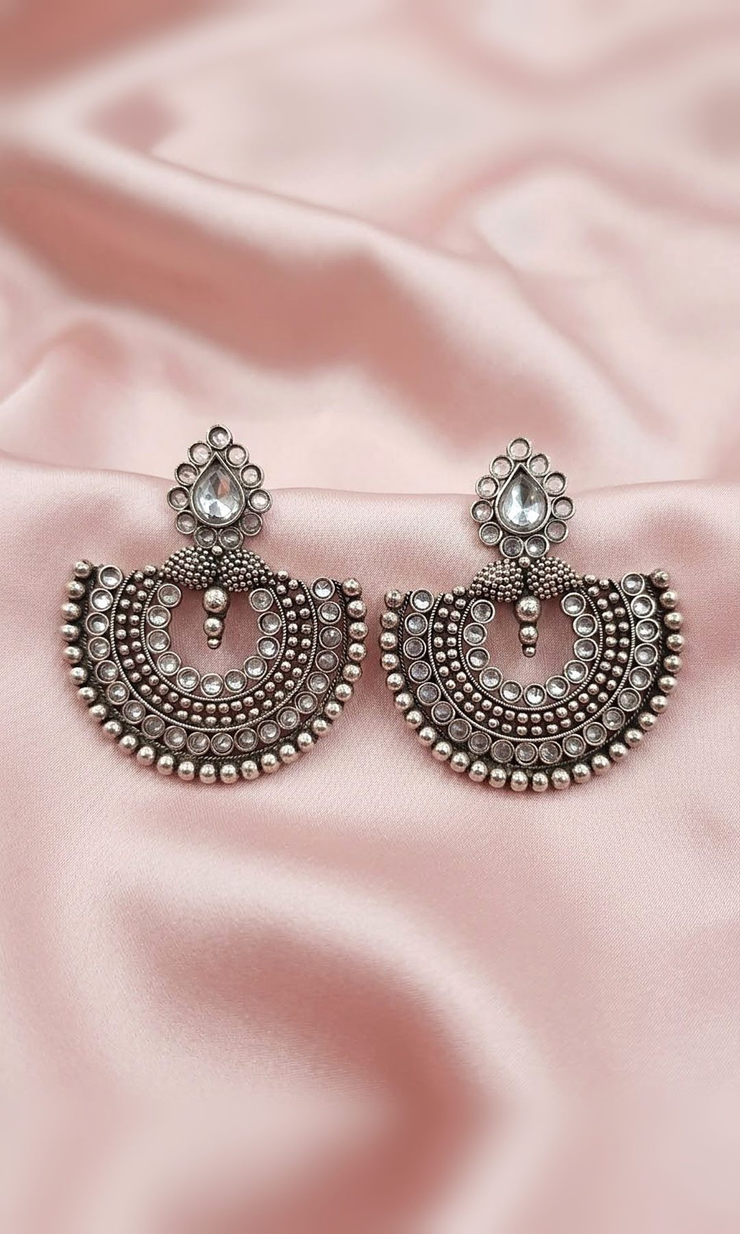 Oxidised Silver Chandbali Earrings — Oxidised silver-tone chandbalis with rows of kundan-look stones, granulated beadwork and a pear-stone stud — a classic match for suits and sarees.