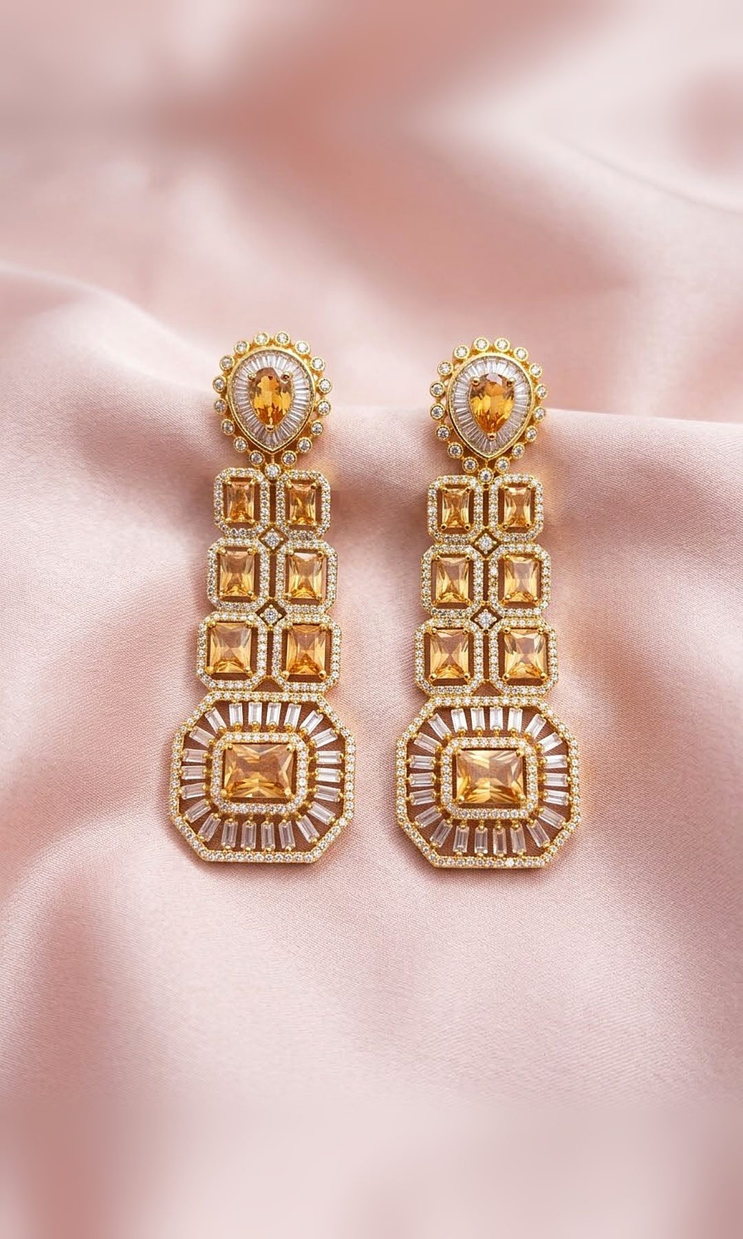 Champagne Stone Long Earrings — Gold-tone long earrings with champagne emerald-cut stones, a pear-stone stud and a baguette sunburst drop.