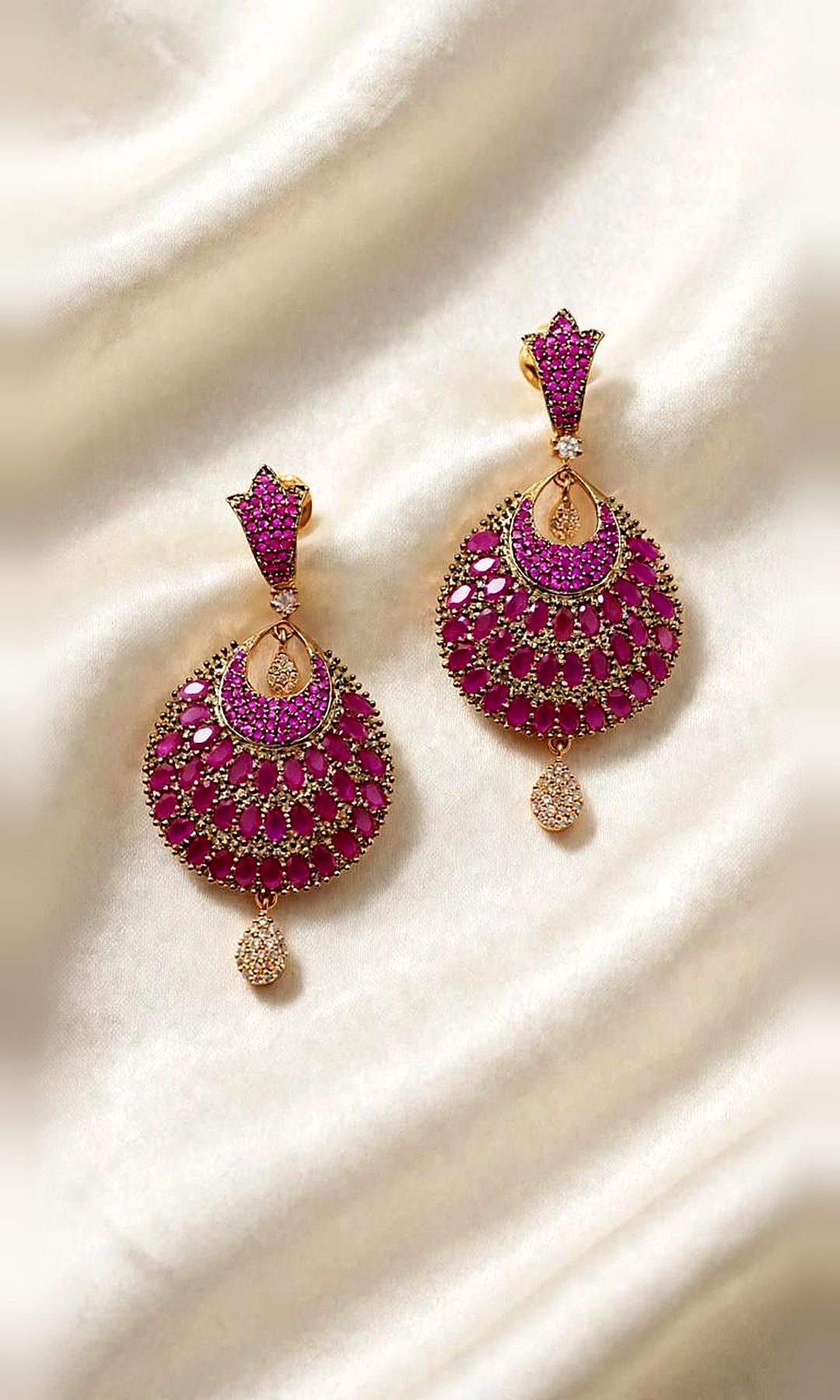 Ruby Pink Pavé Chandbali Earrings — Gold-tone chandbalis densely set with ruby-pink stones, a pavé crescent and a diamond-look teardrop drop.