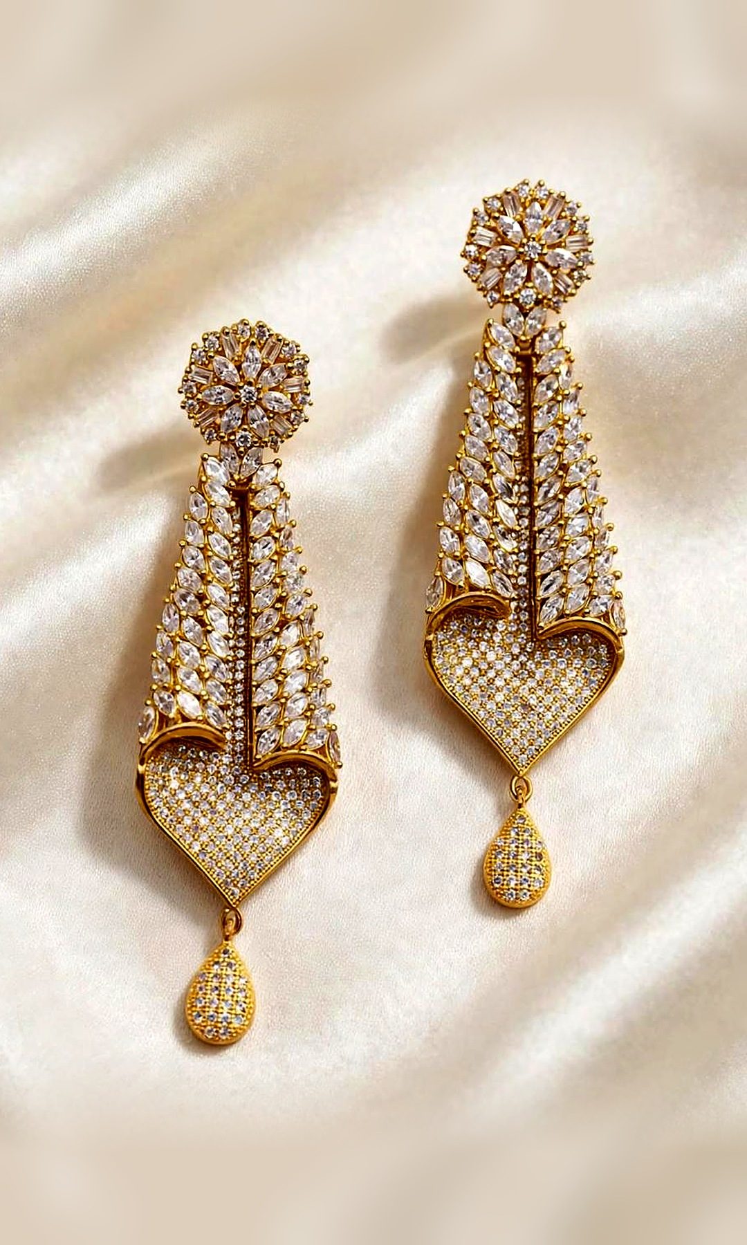 Gold Leaf Heart Drop Earrings — Gold-tone long earrings with a flower stud, cascading marquise-stone leaves, a pavé heart and a teardrop drop.