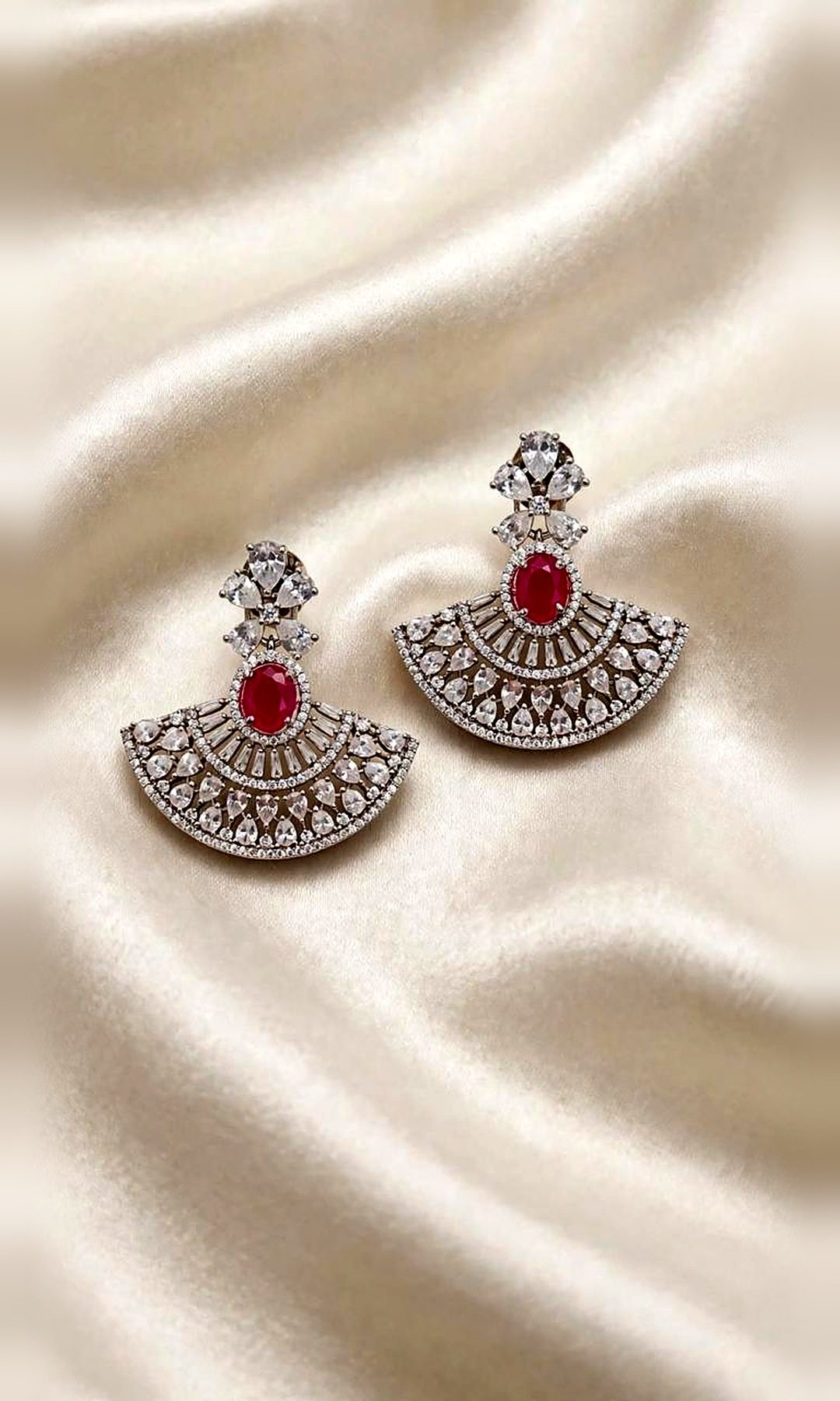 Ruby & Silver Fan Earrings — Silver-tone fan earrings with an oval ruby-red centre stone, baguette rays and pear-cut diamond-look stones.
