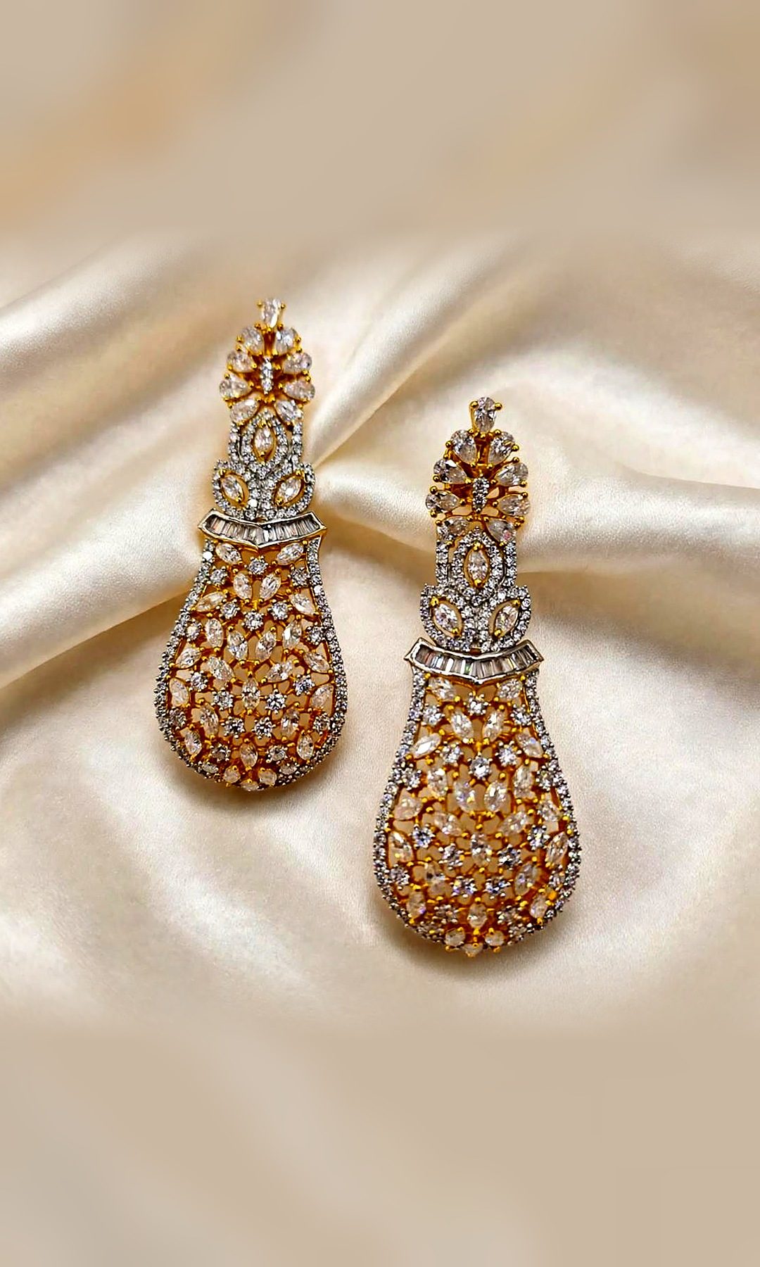 Gold & White Diamond-Look Drop Earrings — Gold-tone long drops with a pear-stone crest, a baguette band and an open lattice of round and marquise diamond-look stones.
