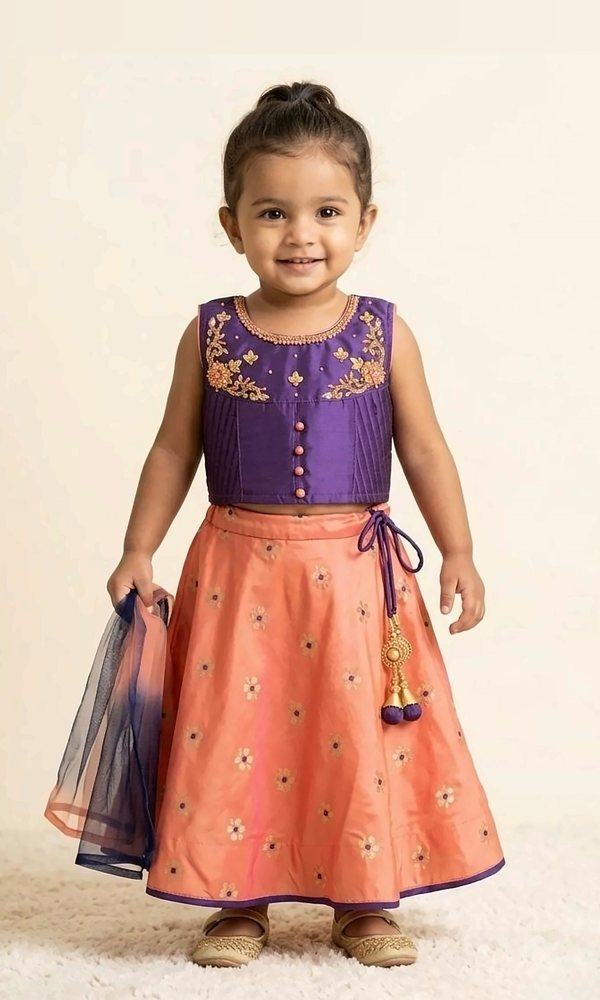 Purple & Peach Lehenga Set — Purple silk blouse with floral hand embroidery and button detail, paired with a peach gold-butti lehenga and an ombré net dupatta.