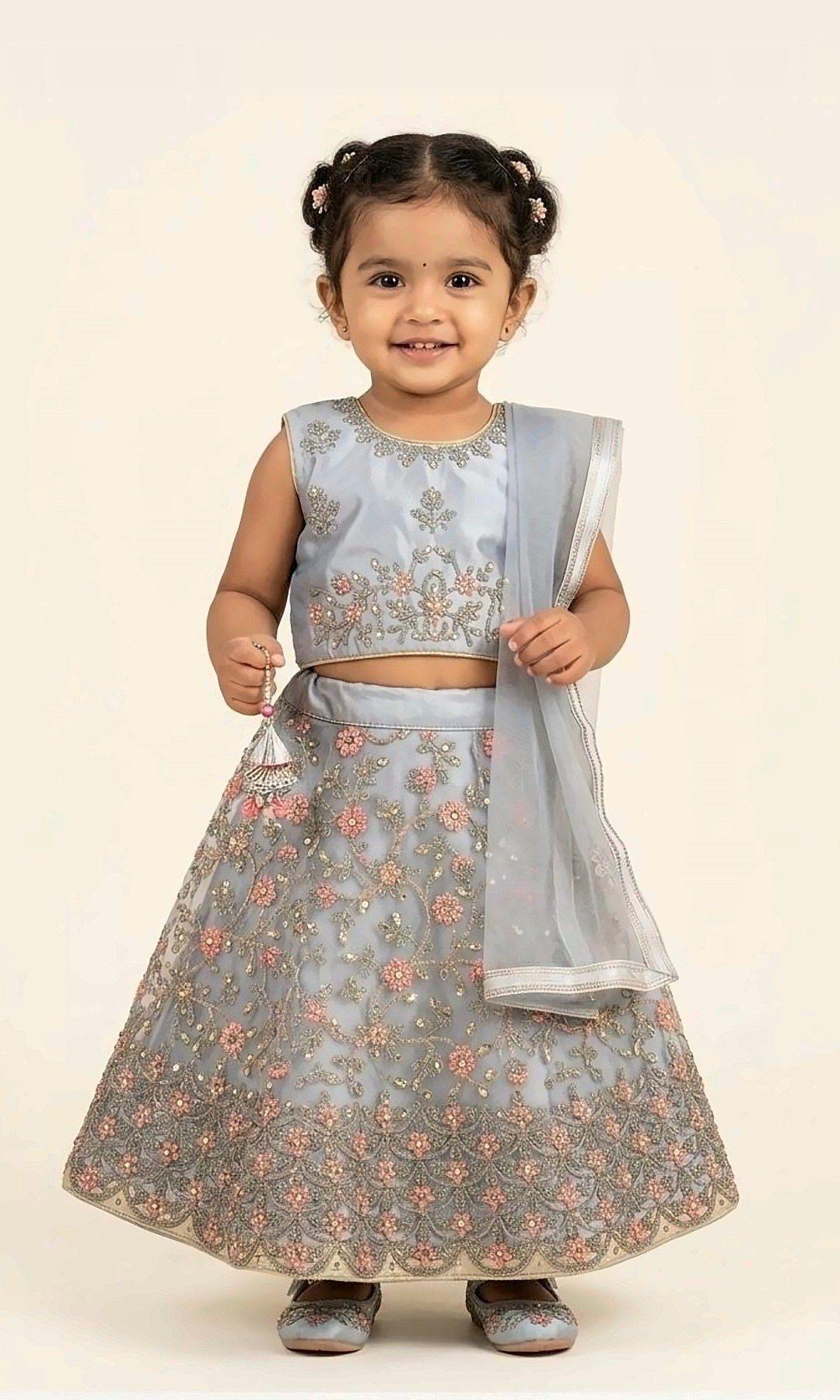 Powder Grey Floral Lehenga — Powder-grey net lehenga choli covered in pink floral and sequin embroidery, finished with a matching grey dupatta — elegant and dreamy.