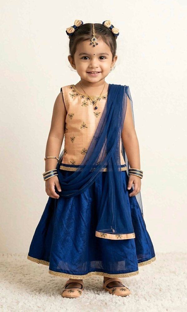 Peach & Navy Lehenga Set — Peach silk blouse with navy star embroidery, a navy lehenga with gold border and a sheer navy net dupatta — classic and graceful.