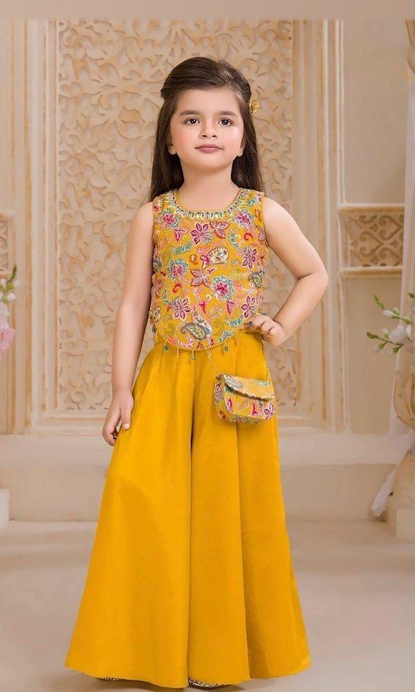 Mustard Paisley Palazzo Set — Mustard silk palazzo with a colourful paisley-embroidered crop top, mirror-work neckline, bead tassels and a matching mini sling bag.