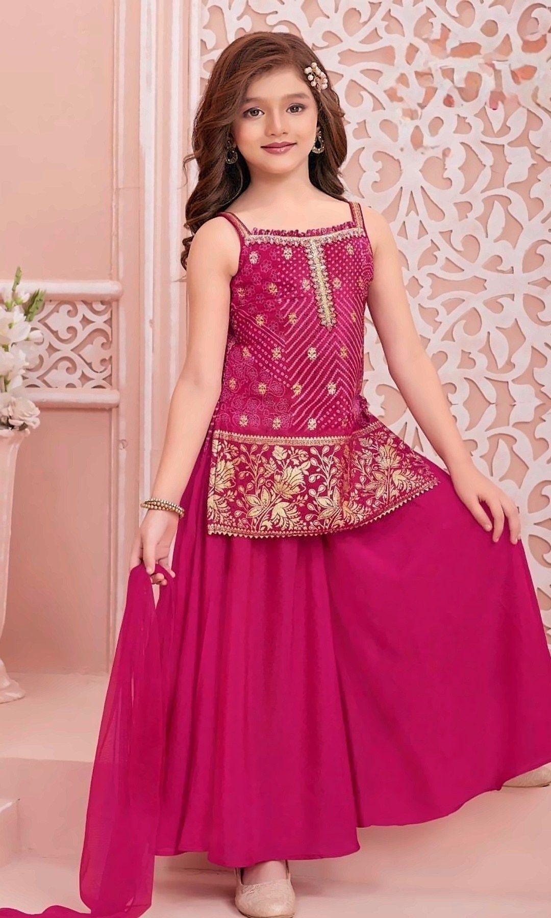 Rani Pink Bandhani Palazzo Set — Rani pink bandhani-print top with a gold floral-embroidered peplum hem, flowing rani palazzo and a matching chiffon dupatta.