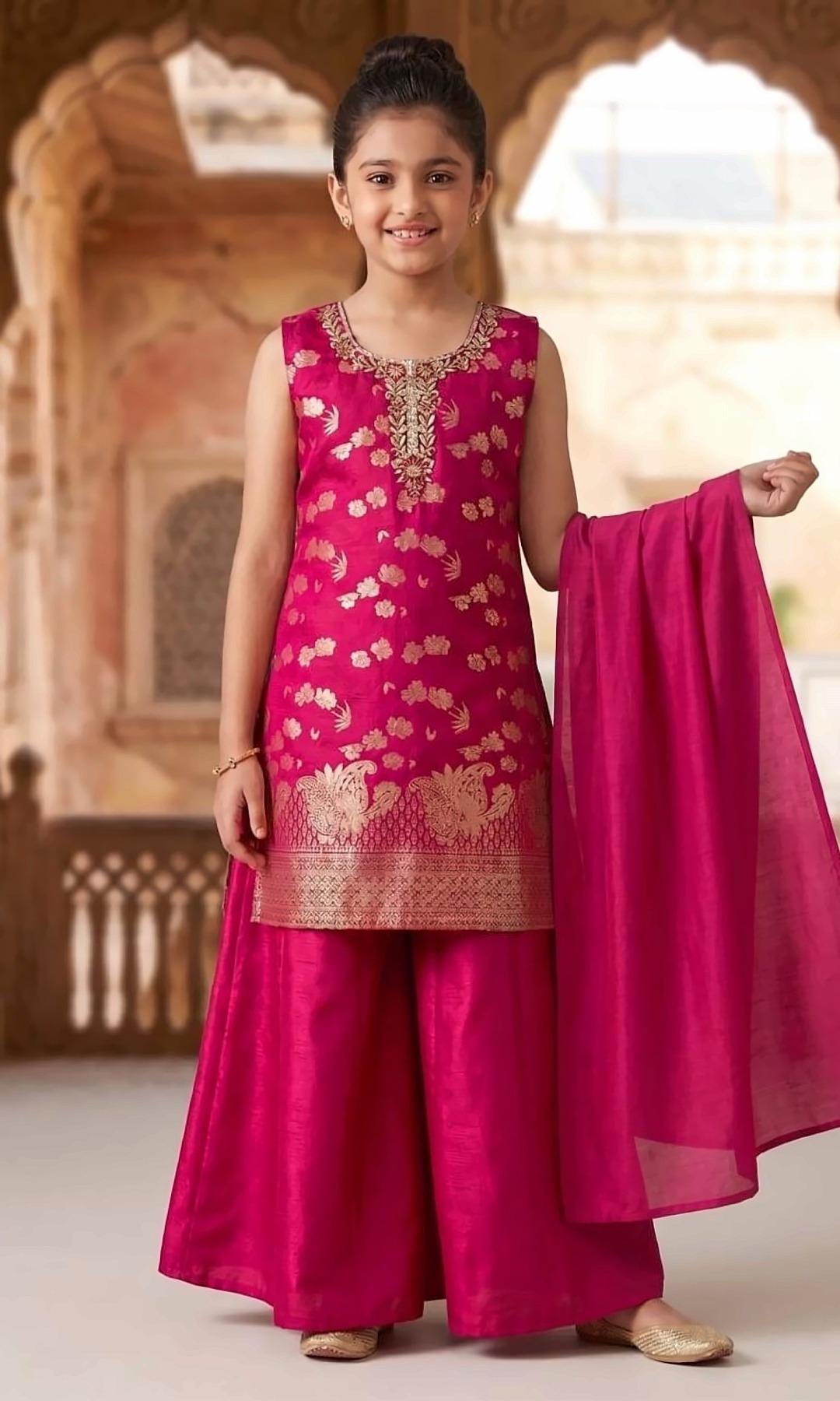 Rani Pink Brocade Palazzo Set — Sleeveless rani pink brocade kurta with gold floral butis, an embroidered yoke and a woven border, a wide silk palazzo and a matching dupatta.