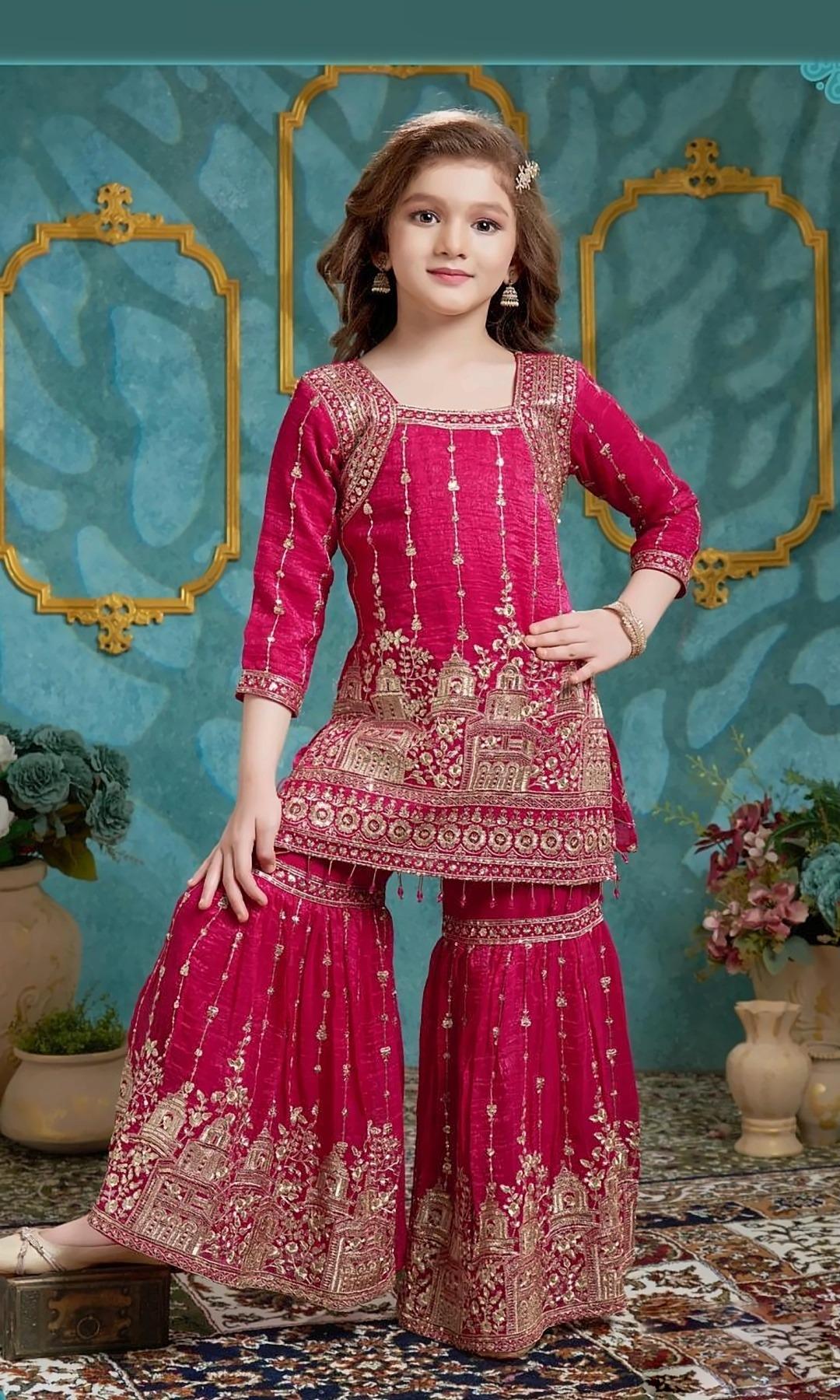 Rani Pink Zari Sharara Set — Rani pink kurti with gold zari palace motifs and sequin lines, and a matching zari-embroidered sharara with a bead-tassel hem.