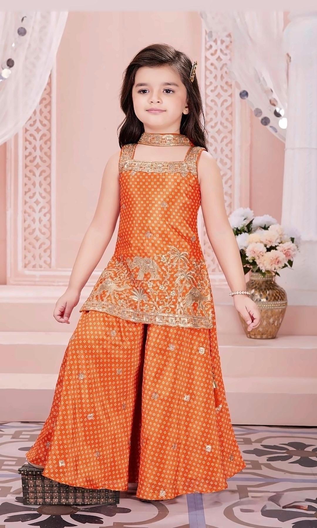 Orange Bandhani Sharara Set — Orange bandhani-print kurti with gold elephant and palm embroidery, a matching flared sharara and a choker-style dupatta.