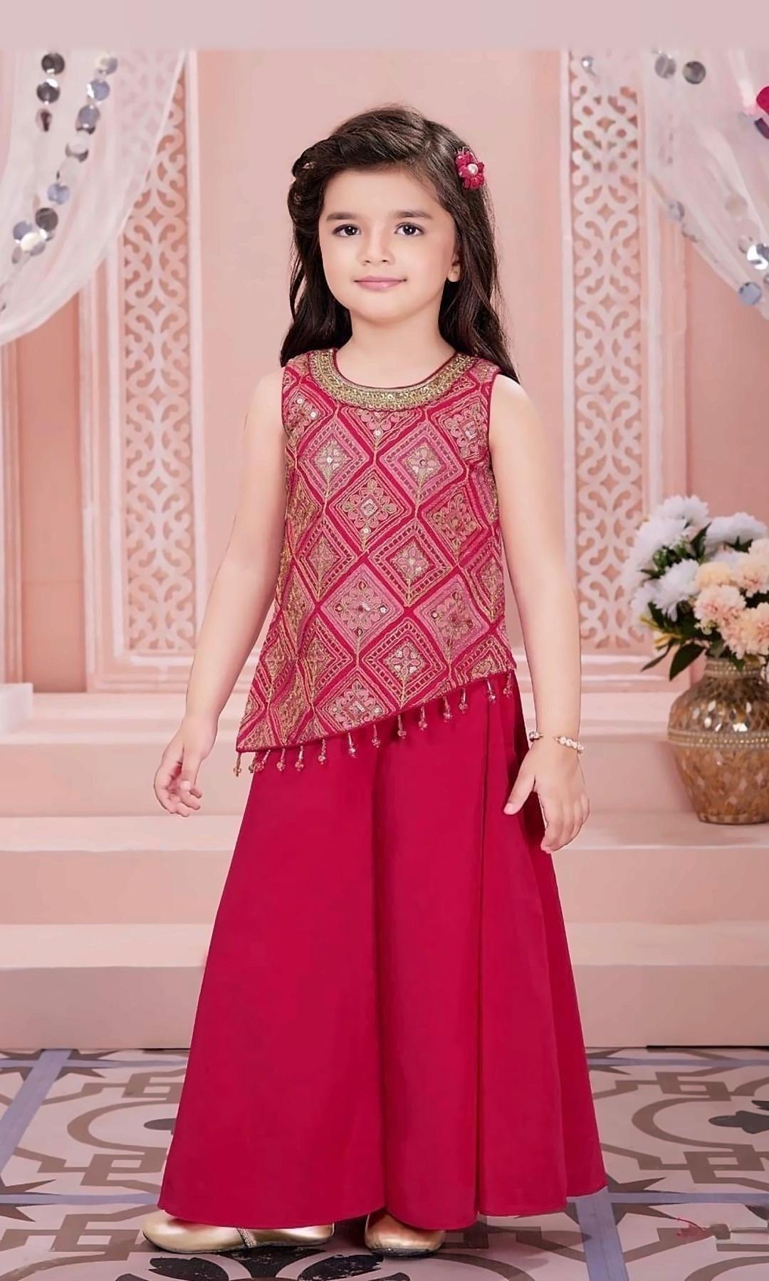 Rani Pink Asymmetric Palazzo Set — Rani pink asymmetric top with gold diamond-pattern embroidery and bead tassels, paired with a flowing palazzo.