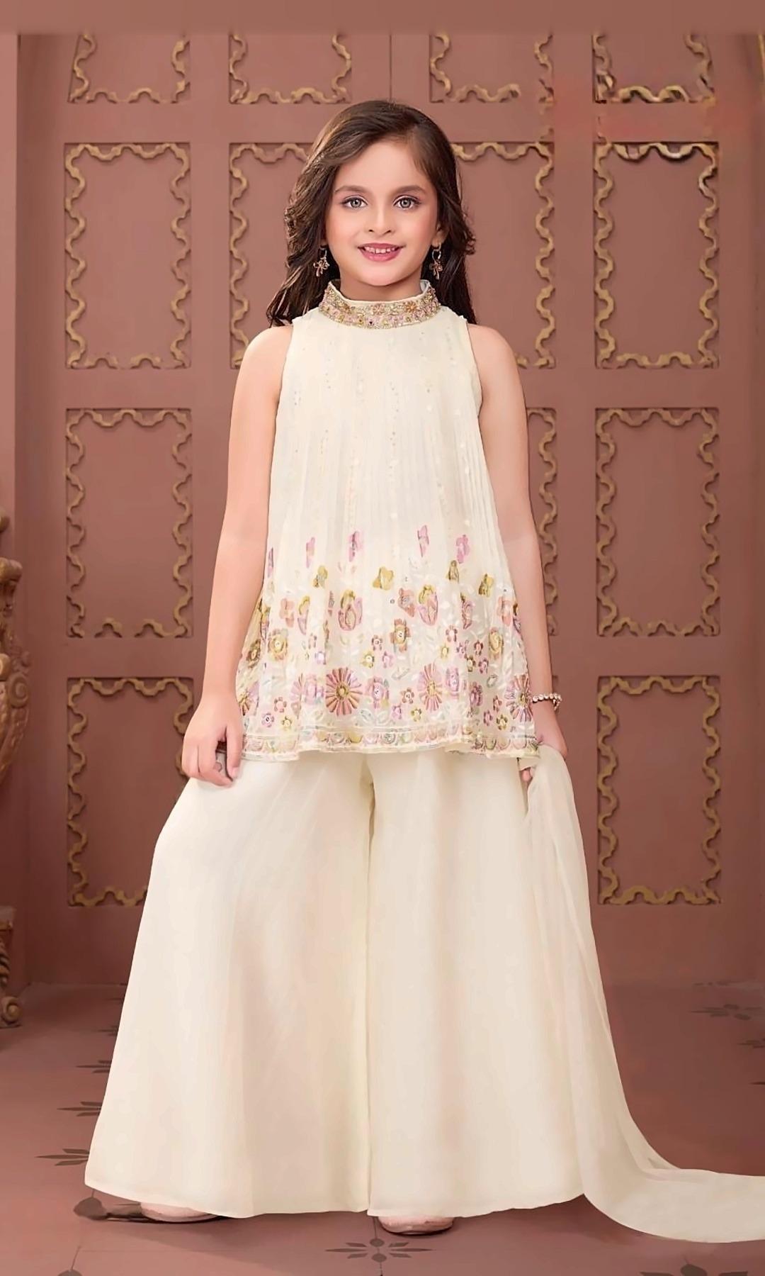 Ivory Pleated Sharara Set — Ivory high-neck pleated top with pastel floral embroidery and a jewelled collar, a crushed sharara and a matching dupatta.