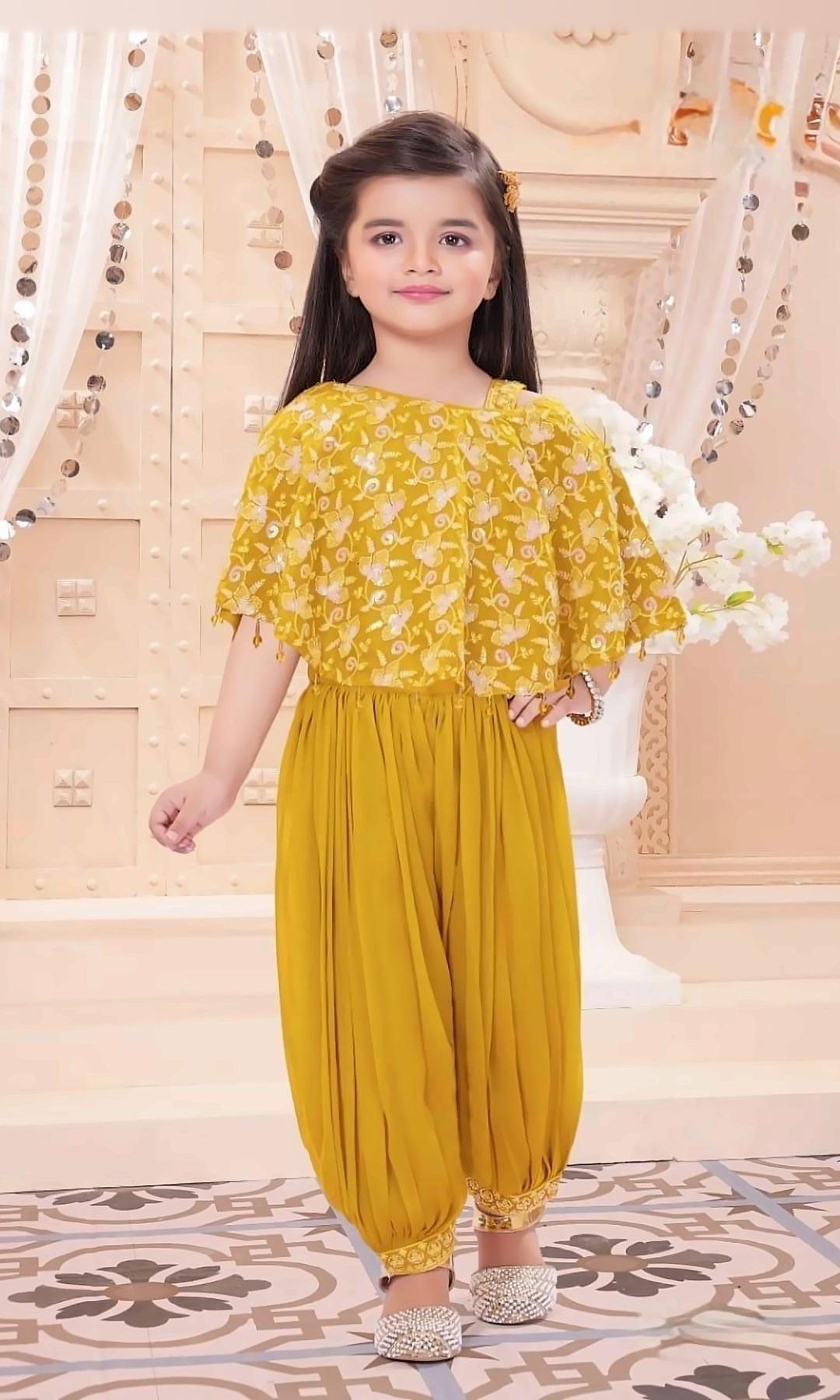 Mustard Cape Dhoti Set — Mustard cold-shoulder cape top with sequin floral embroidery and bead tassels, paired with draped dhoti pants.