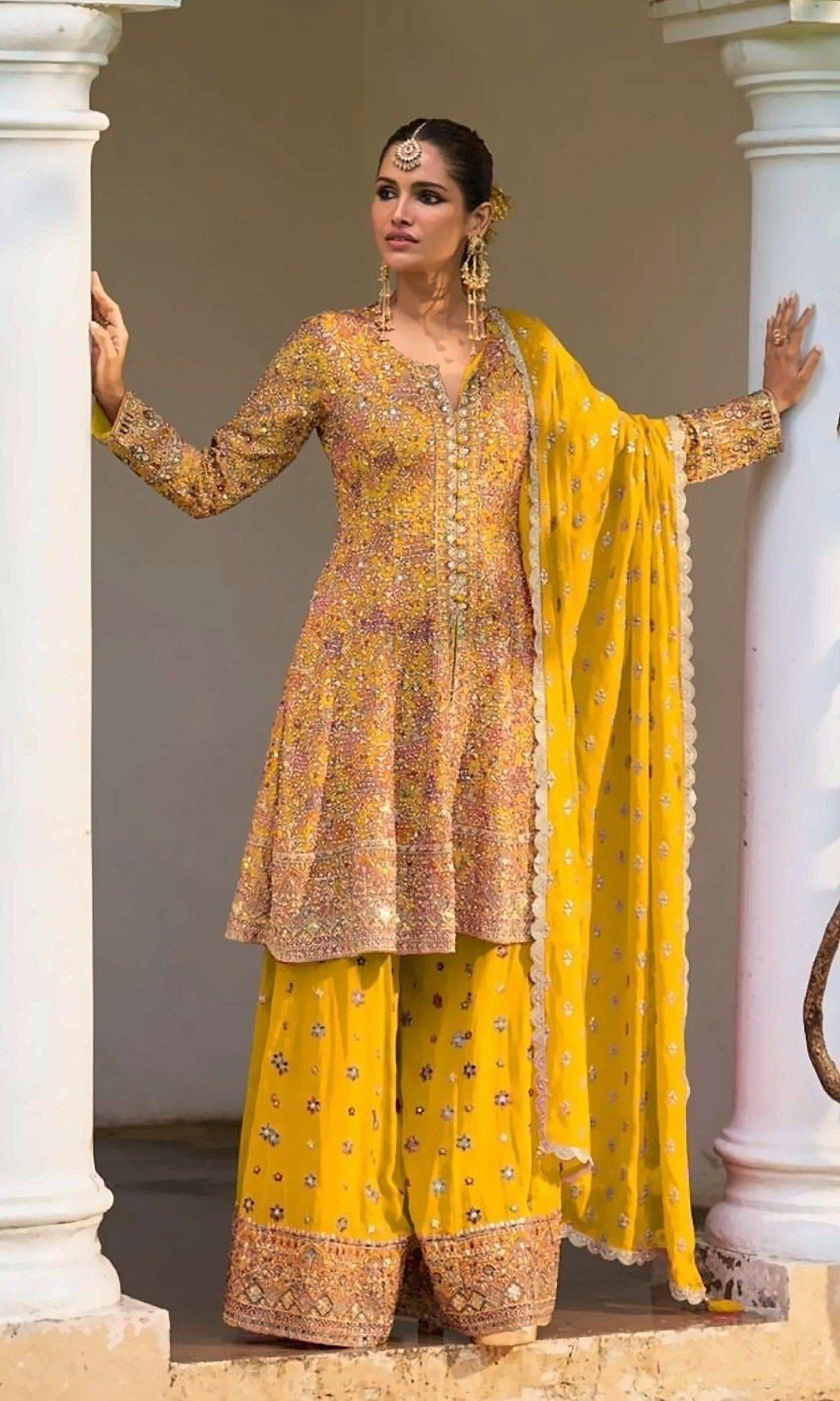 Mustard Yellow Peplum Sharara Suit — Sunny mustard peplum kurta with colourful mirror and sequin work, a star-motif sharara and a scalloped dupatta — perfect for haldi and mehendi.