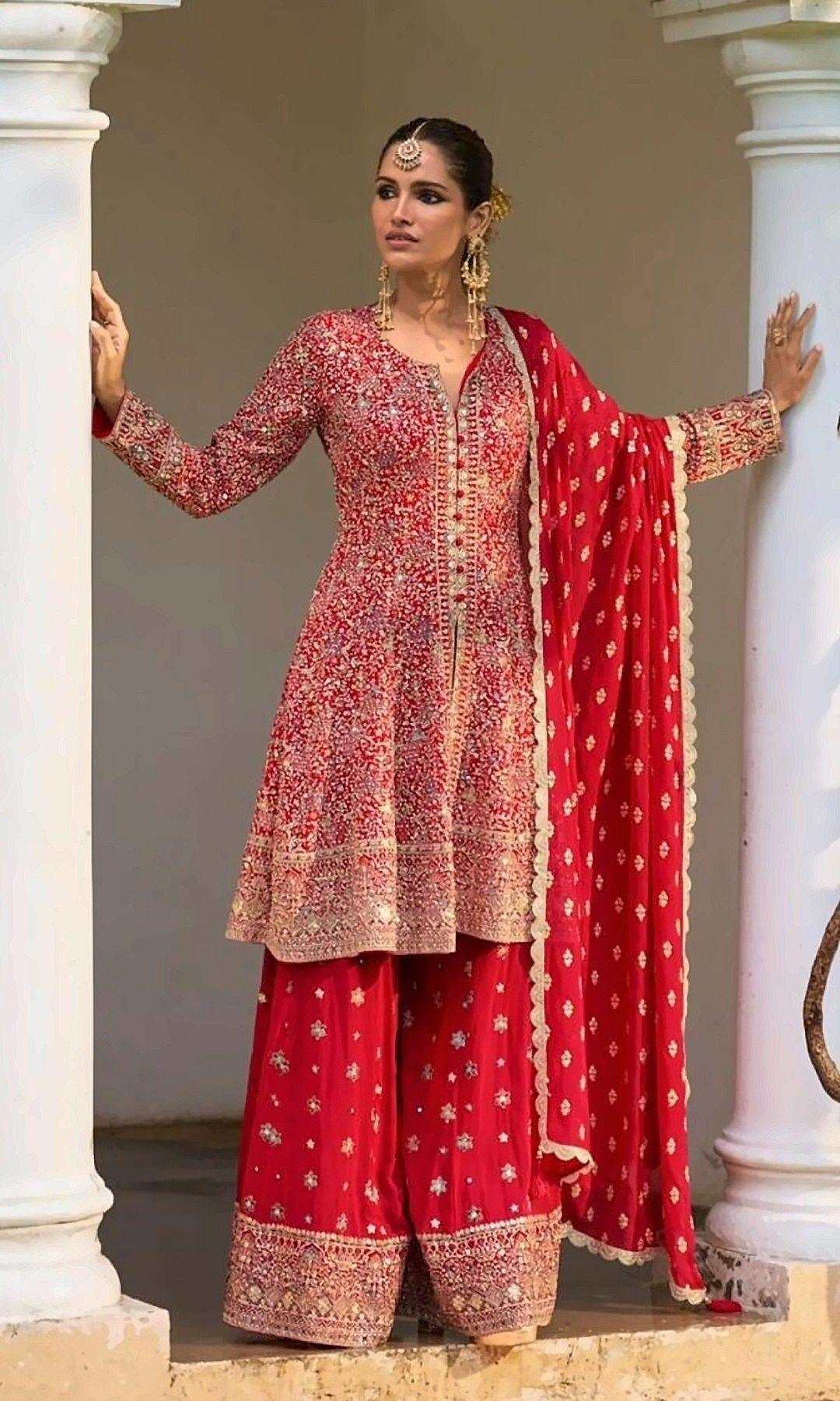 Red Peplum Sharara Suit — Festive red peplum kurta with rich sequin embroidery, a wide sharara with a gold border and a matching butti dupatta.