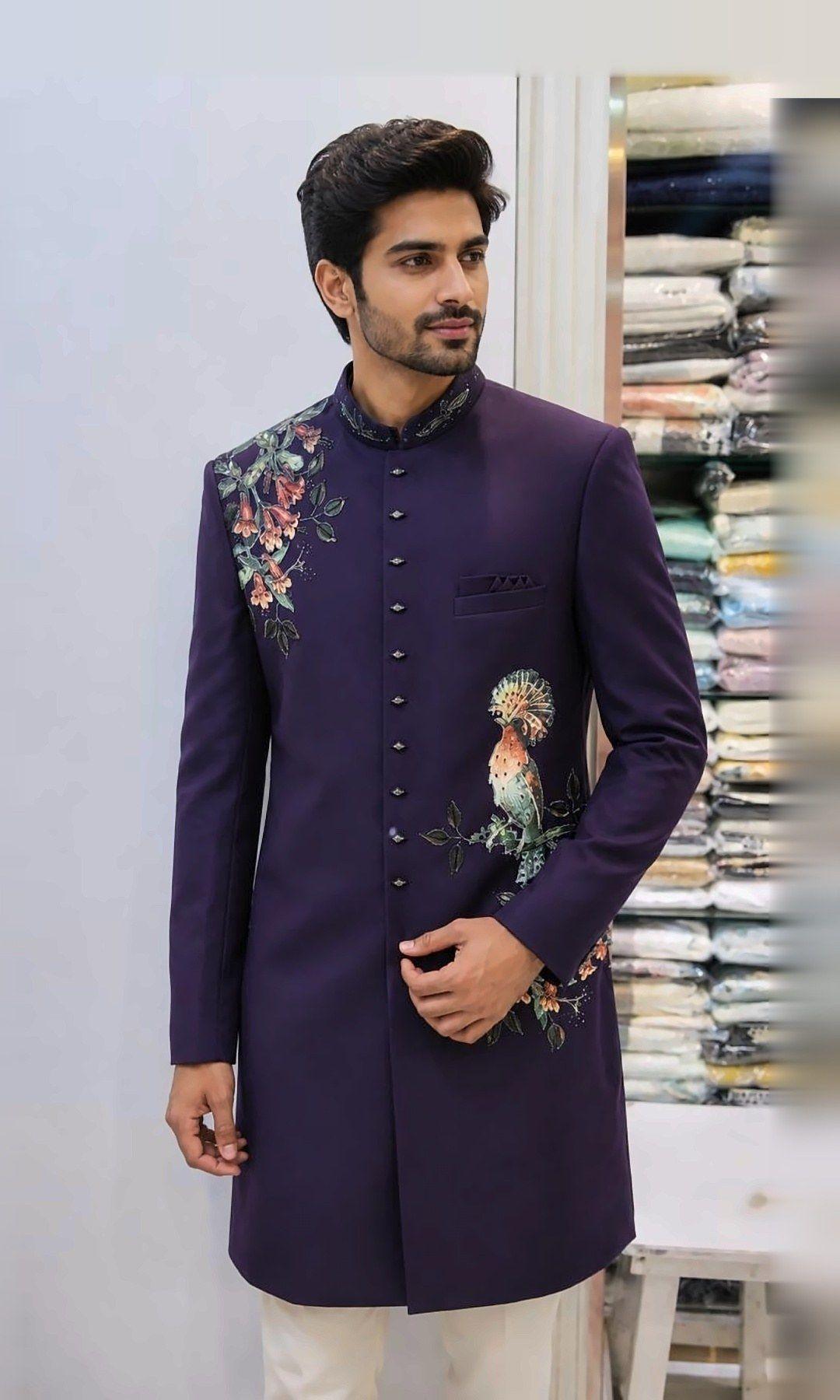 Plum Sherwani with Peacock Embroidery — Deep plum sherwani with hand-embroidered flowering vines on the shoulder, a peacock motif at the waist and an embroidered collar.