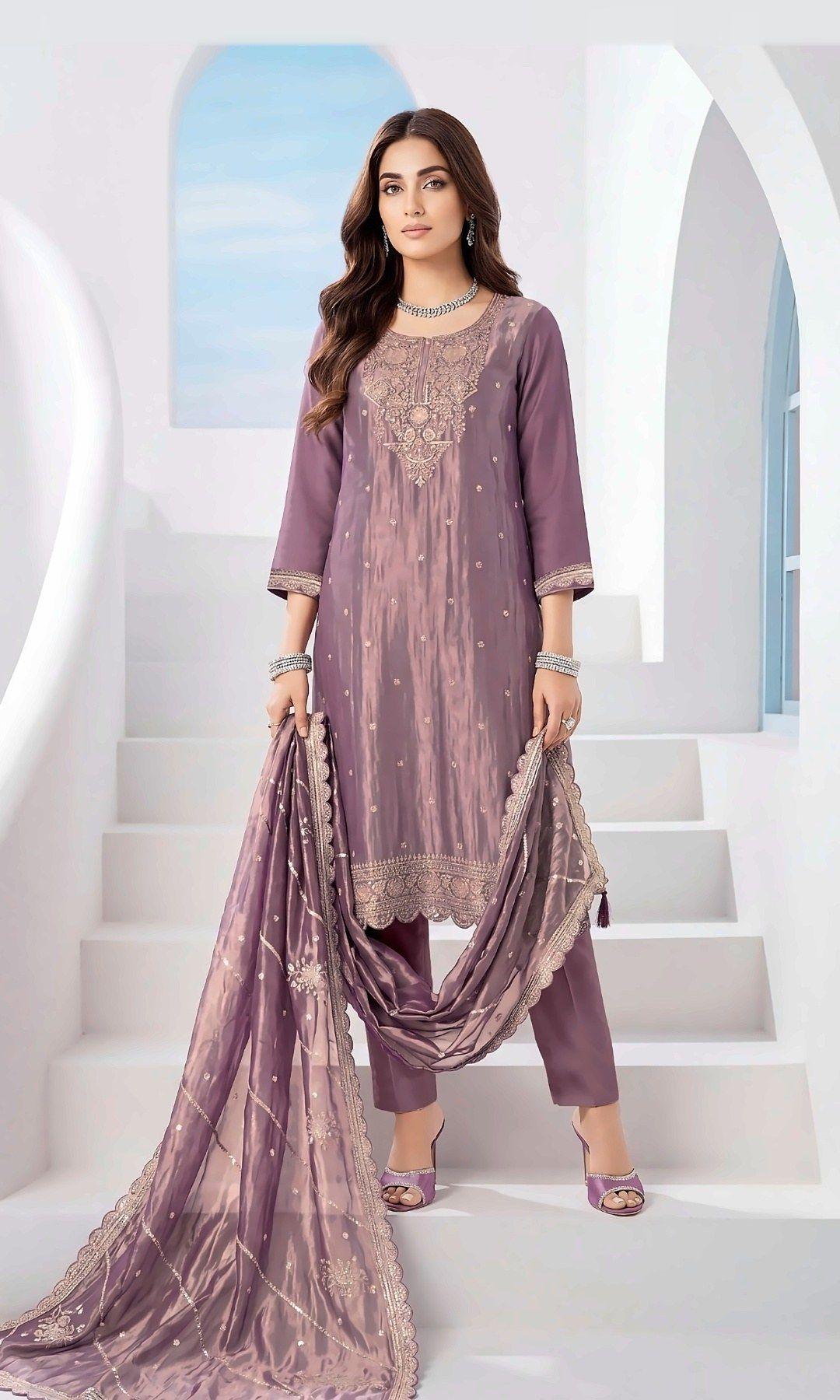 Mauve Tissue Silk Embroidered Suit — Shimmering tissue-silk suit with a rich embroidered yoke, scalloped hem and a sequin-striped scalloped dupatta. Unstitched suit set.